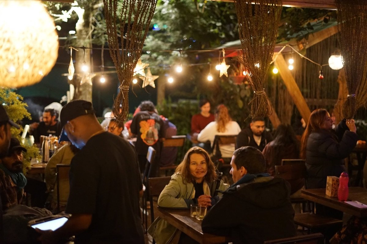Outdoor tables at night under string lights